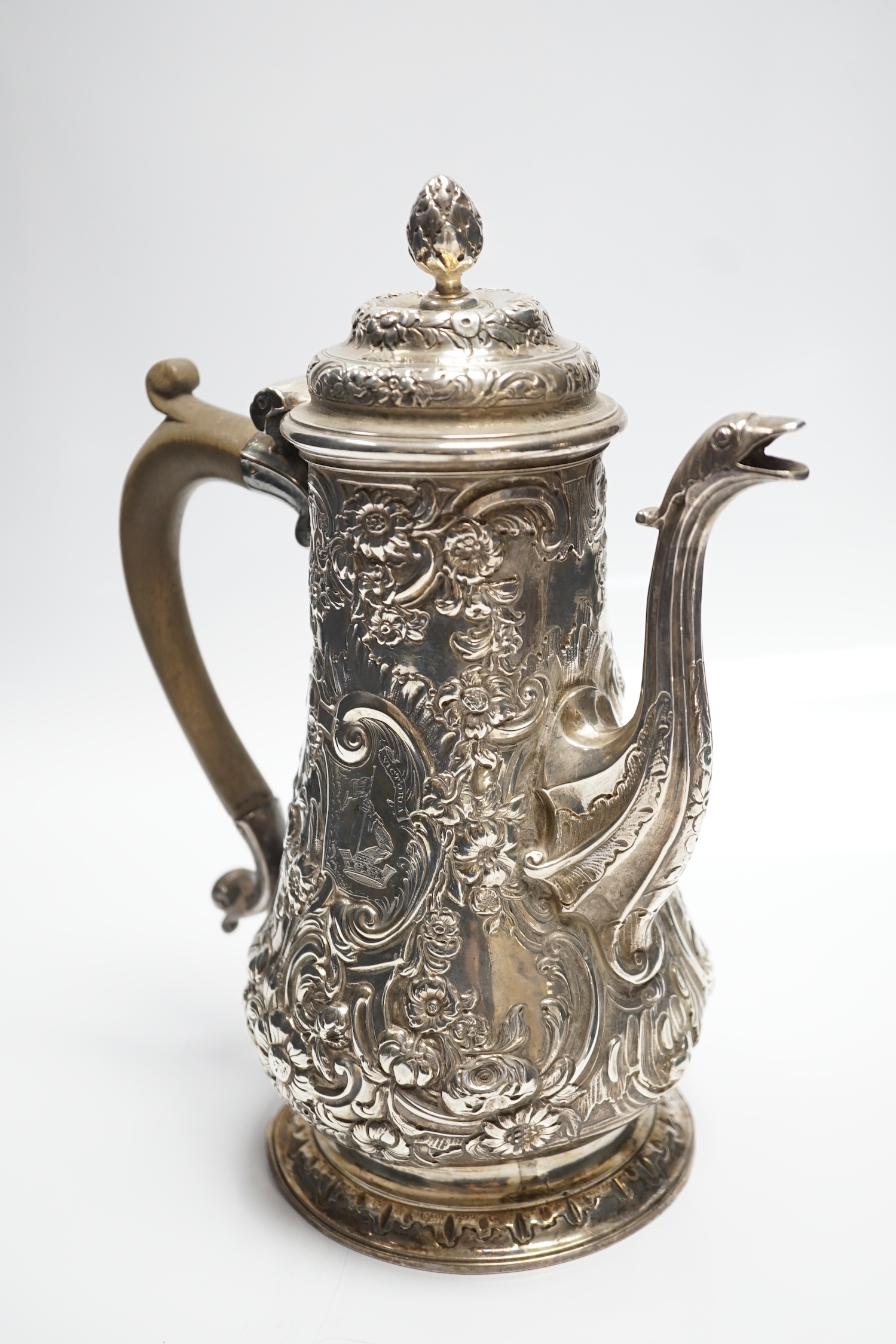 A George II silver baluster coffee pot, with later embossed decoration, maker, ?W, London, 1751, height 25.5cm, gross weight 31.3oz.